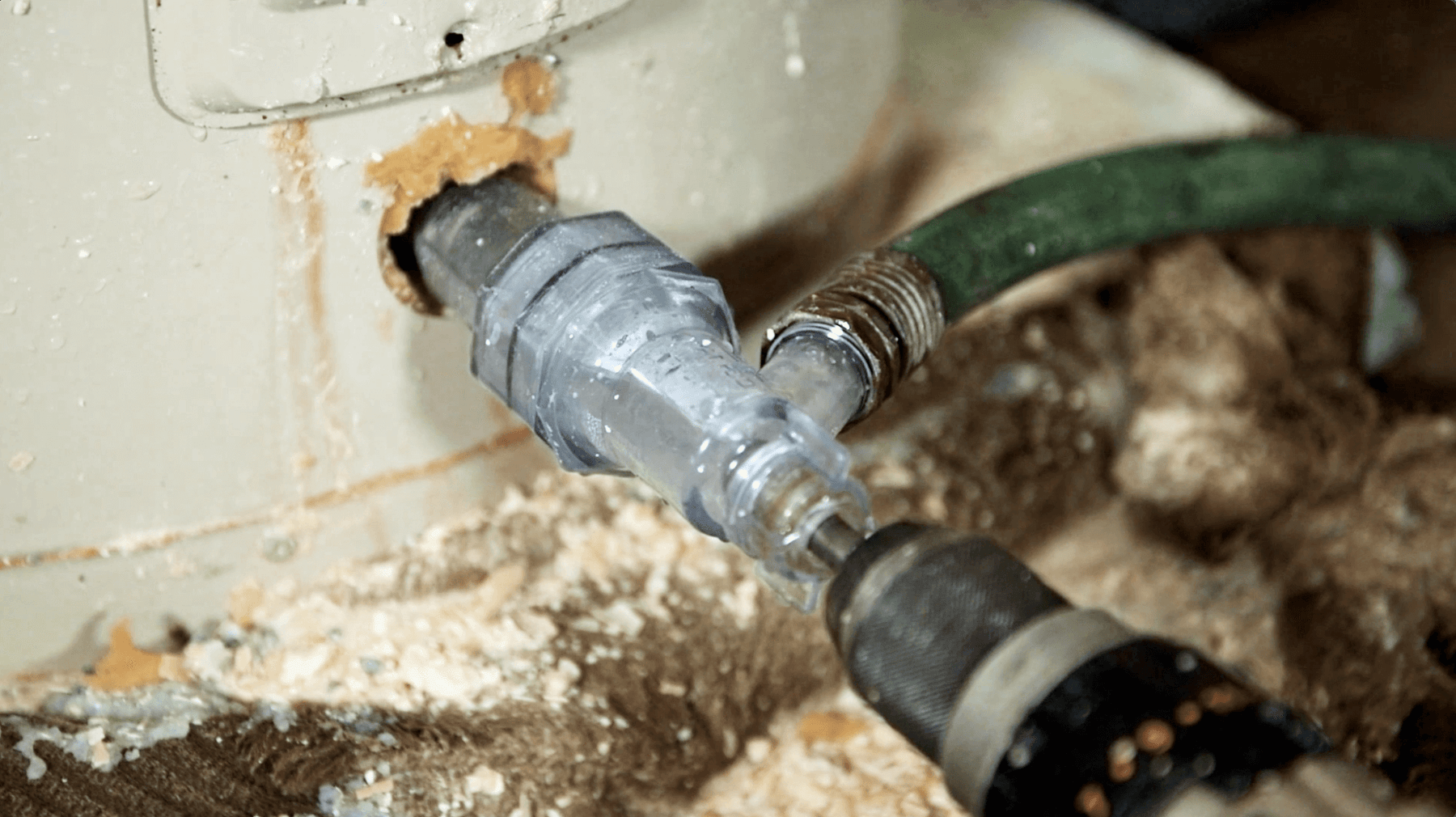 Turbo Tank Cleaner connected to a water heater during a cleaning demonstration