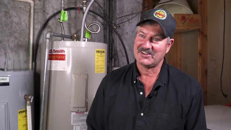 Turbo Tank Cleaner founder beside water heaters